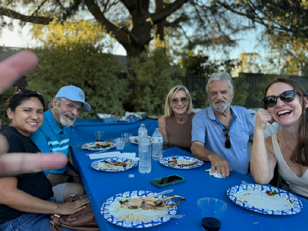 Basket of crab sitting on a dock with the ocean in the background.